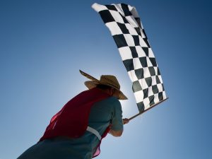 Person waving checkered race flag